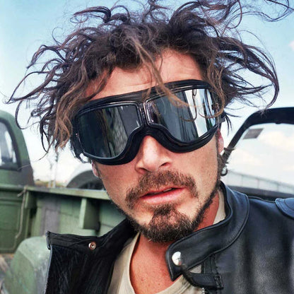 Retro motorcycle goggles worn by rider in leather jacket