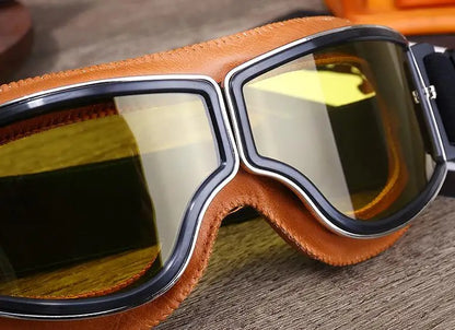 Retro motorcycle goggles brown leather frame with yellow mirror lens close-up